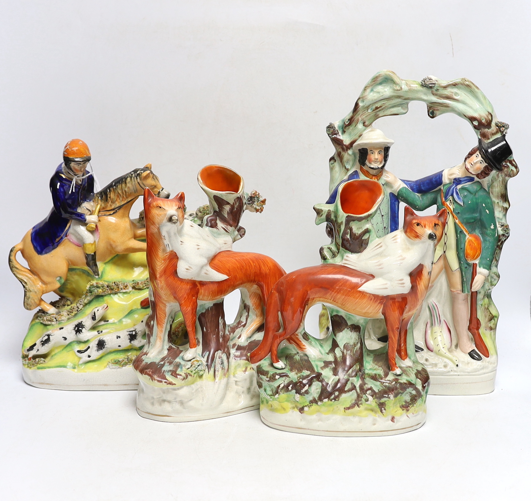 Two mid 19th century Staffordshire hunting figure groups and a pair of fox spill vases, 33cm